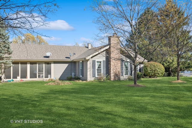 exterior space featuring a lawn and a sunroom