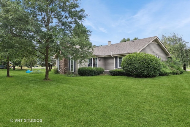 view of side of property featuring a lawn