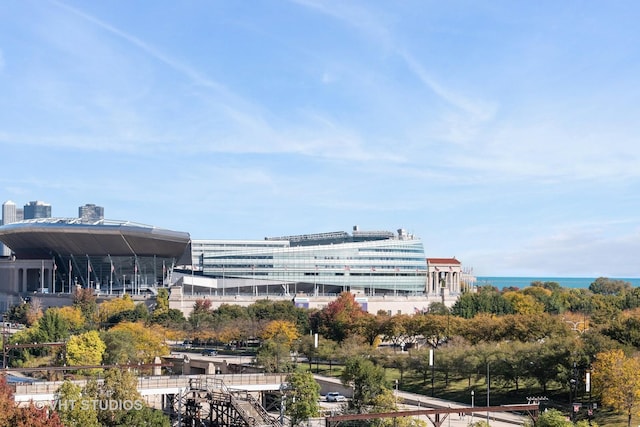 view of building exterior featuring a city view and a water view