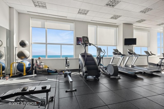 exercise room featuring plenty of natural light, visible vents, and a drop ceiling