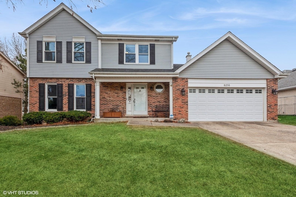 front of property featuring a front yard and a garage