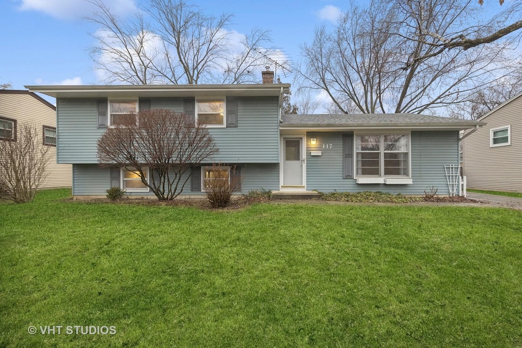 split level home featuring a front lawn