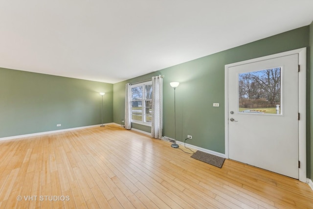 unfurnished room with a wealth of natural light and light wood-type flooring