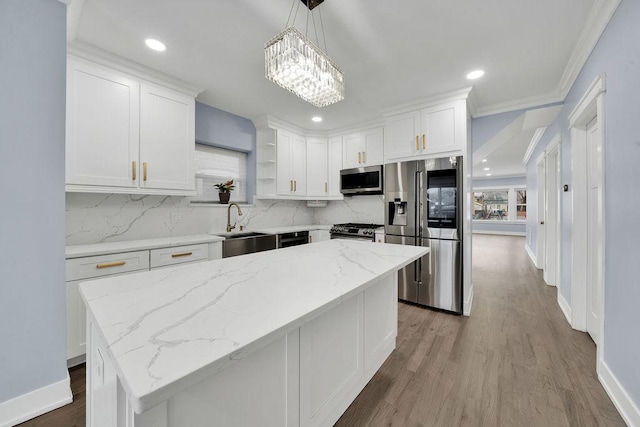 kitchen featuring pendant lighting, backsplash, an inviting chandelier, white cabinetry, and stainless steel appliances