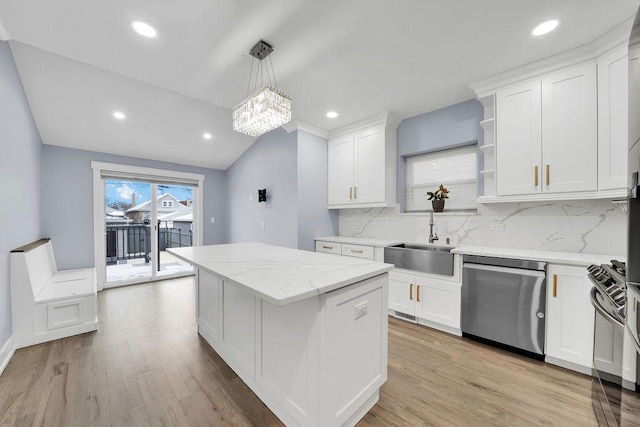 kitchen featuring dishwasher, backsplash, and white cabinets