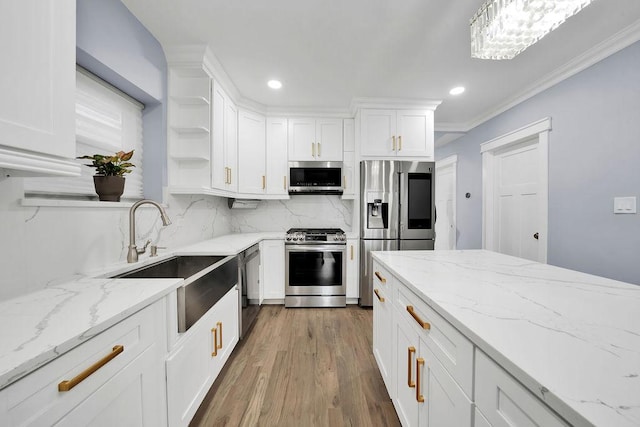 kitchen with tasteful backsplash, white cabinets, and stainless steel appliances