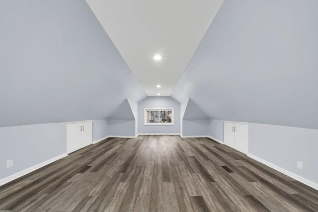 bonus room featuring dark hardwood / wood-style floors and vaulted ceiling