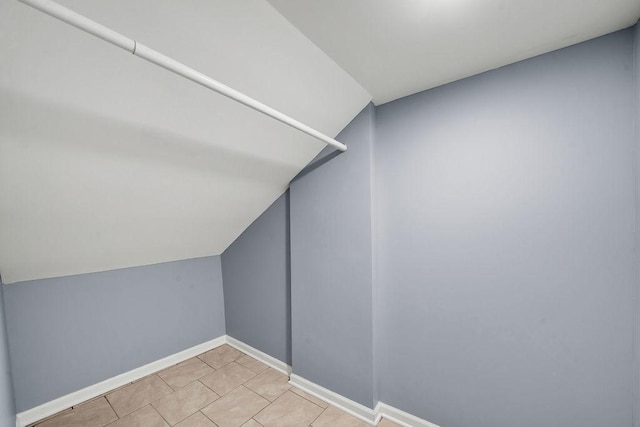 walk in closet with vaulted ceiling