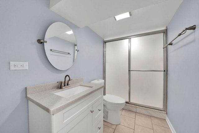 bathroom featuring tile patterned flooring, vanity, toilet, and a shower with door