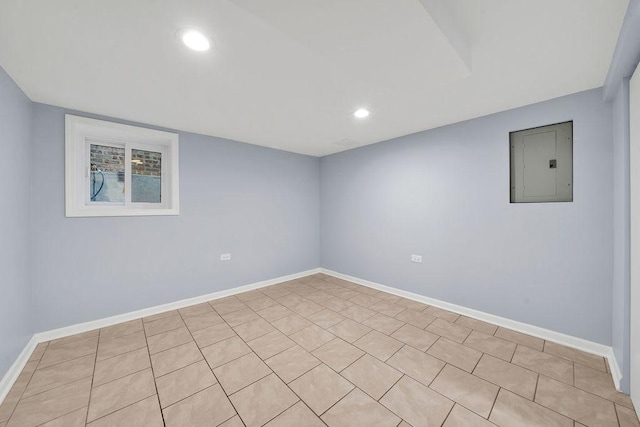 empty room with electric panel and light tile patterned floors