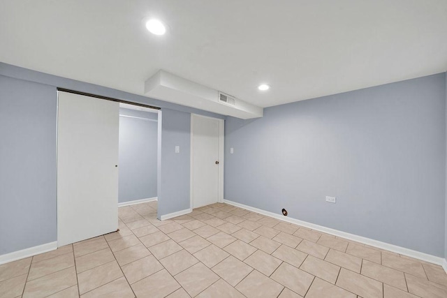 basement featuring light tile patterned floors