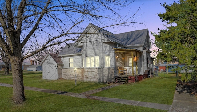 property exterior at dusk with a lawn