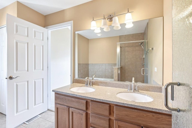 bathroom with an enclosed shower, vanity, and tile patterned floors