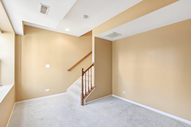 basement featuring light carpet