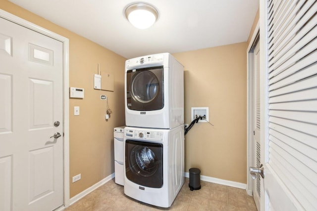 clothes washing area featuring stacked washer and dryer