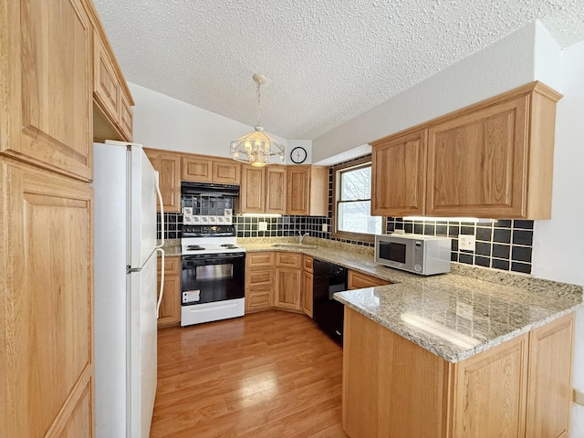 kitchen featuring pendant lighting, dishwasher, range with electric stovetop, kitchen peninsula, and white fridge