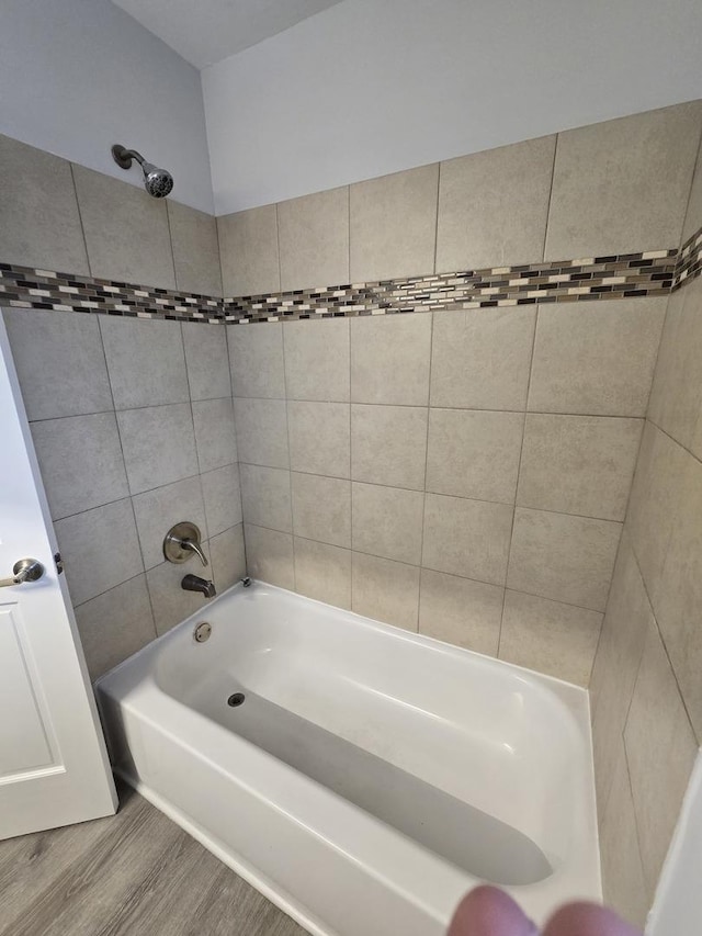 bathroom with wood-type flooring and tiled shower / bath combo