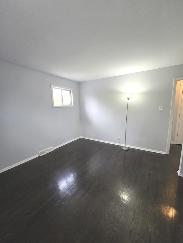 unfurnished room with dark hardwood / wood-style floors