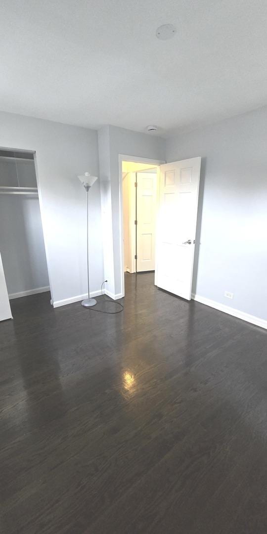 spare room with dark hardwood / wood-style flooring