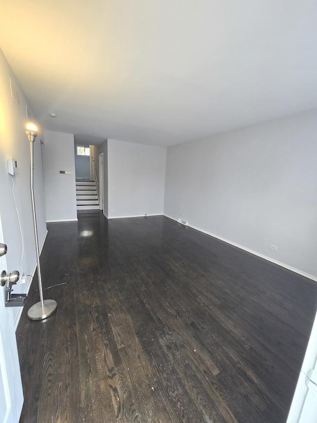 unfurnished living room featuring dark hardwood / wood-style floors