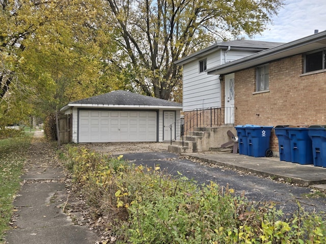 view of side of property with a garage and an outdoor structure