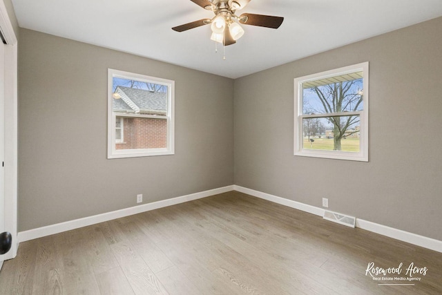 spare room featuring light wood-type flooring and ceiling fan