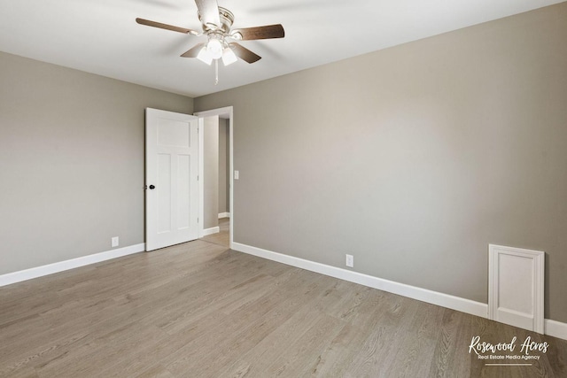 empty room featuring ceiling fan and light wood-type flooring