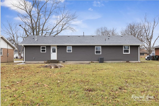 back of property featuring a lawn and cooling unit