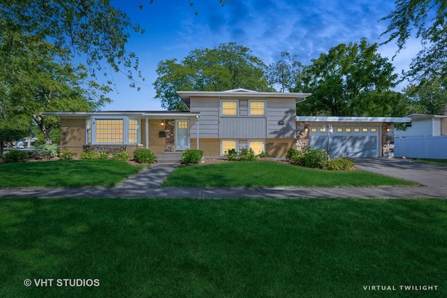 split level home with a garage and a front lawn