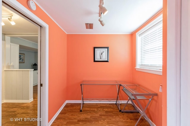 interior space featuring hardwood / wood-style floors and rail lighting