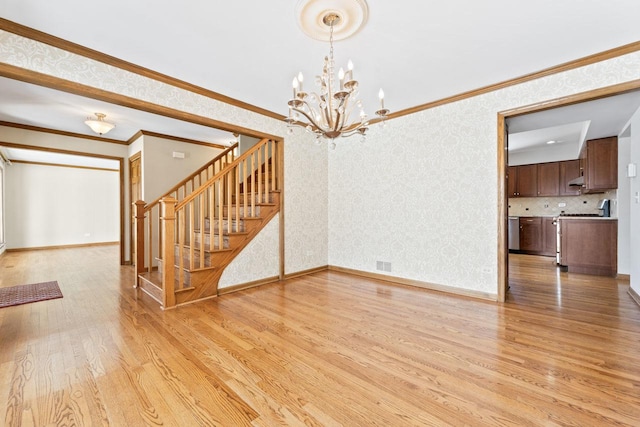 interior space featuring ornamental molding, a chandelier, and light wood-type flooring