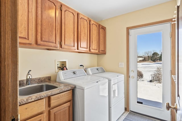 laundry area with cabinets, independent washer and dryer, sink, and light tile patterned floors