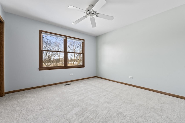 carpeted empty room featuring ceiling fan