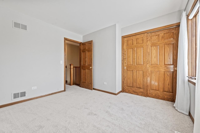 unfurnished bedroom with carpet floors and a closet