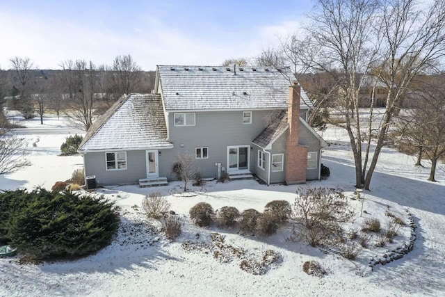 view of snow covered back of property