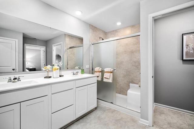 bathroom with vanity and walk in shower