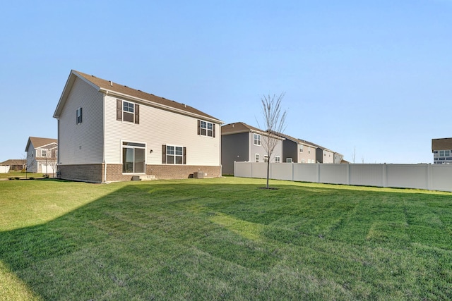 rear view of house with a lawn