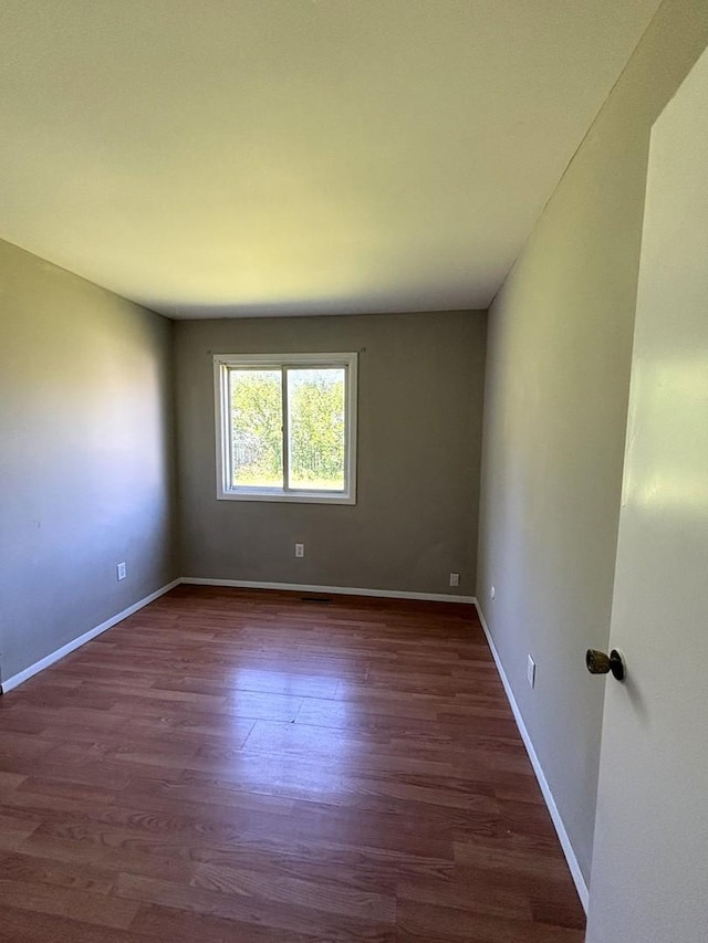 empty room featuring dark hardwood / wood-style floors