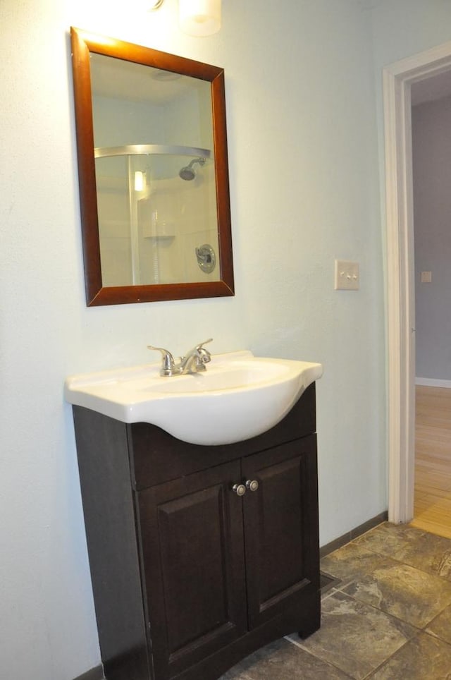 bathroom featuring a shower and vanity