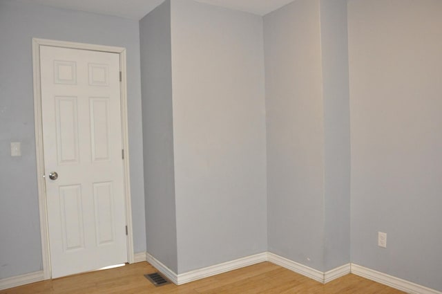 unfurnished room featuring hardwood / wood-style floors