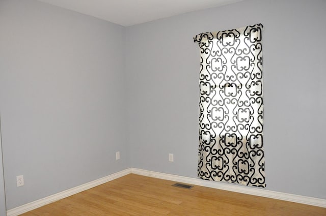 spare room with wood-type flooring