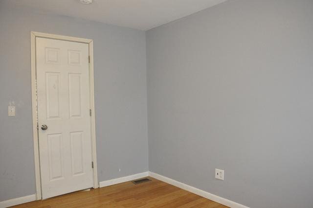 spare room with hardwood / wood-style floors