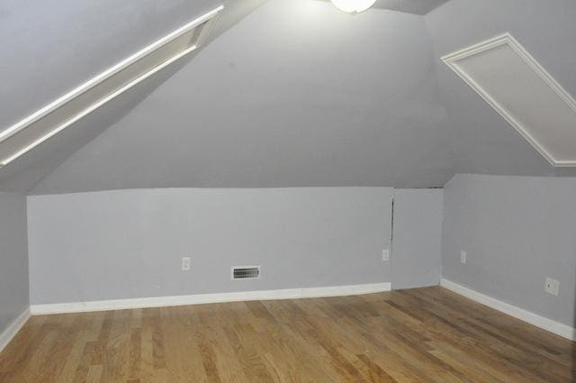 bonus room with wood-type flooring and lofted ceiling