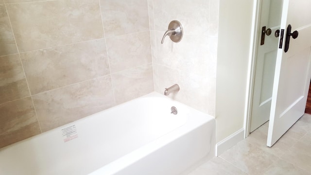 bathroom with tile patterned flooring and tiled shower / bath combo