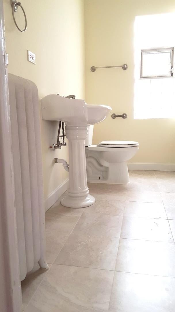 bathroom with tile patterned floors and toilet