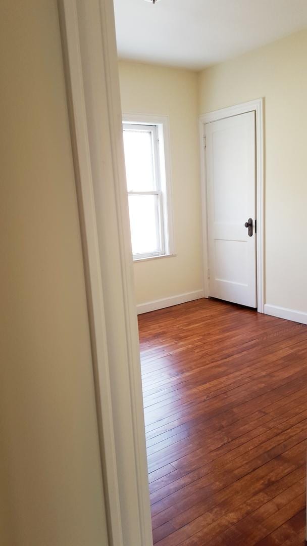 empty room with dark wood-type flooring