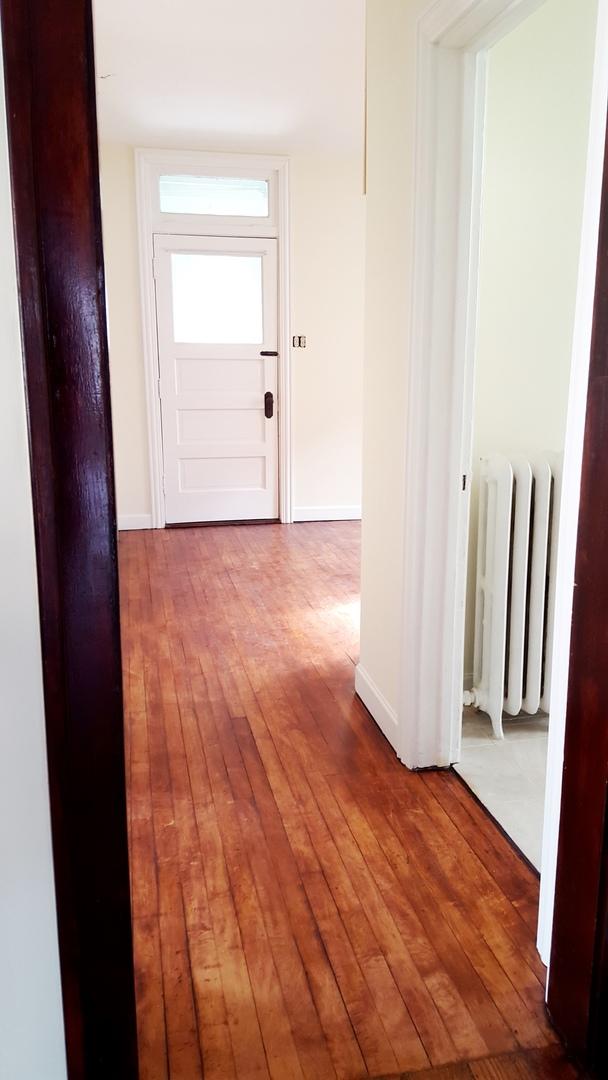 corridor with hardwood / wood-style floors and radiator