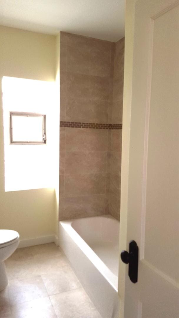 bathroom featuring tile patterned flooring and toilet