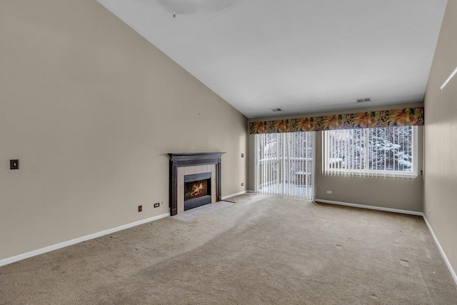 unfurnished living room featuring a fireplace, light colored carpet, and vaulted ceiling