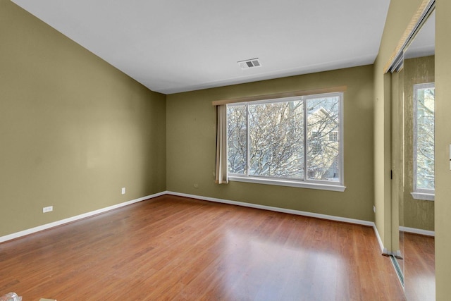 spare room with light hardwood / wood-style flooring